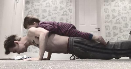 Tom Fletcher does press ups with son on his back