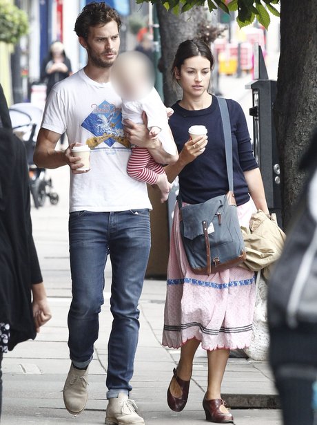 Jamie Dornan enjoys a summer stroll with his wife Amelia and their ...